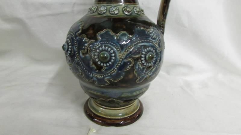 An 1875 Doulton Lambeth 9" George Tinworth narrow necked jug with handle. Decorated with brown, blue - Image 2 of 4