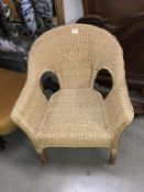 A cane and rafia low back conservatory armchair