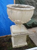 A decorative leaf pattern urn on square pedestal. (Combines 89cm tall x 53 cm diameter) Collect