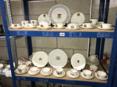 2 shelves of crested china plates, cups and saucers