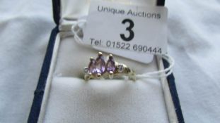 A three stone 9ct gold diamond and amethyst ring, size O.