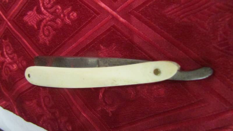 An antique ivory page turner (a/f) glove stretchers, ruler, cut throat razor, paperknife and book - Image 2 of 31