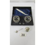 A cased pair of silver rimmed salts with spoons, a silver lidded pill box and a silver mustard