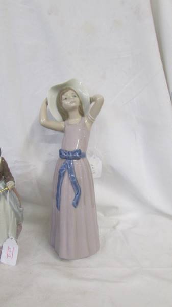 A Lladro figure of a girl with a parasol and another of a girl in hat. - Image 2 of 4