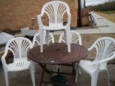 5 white plastic garden chairs, a parasol base and a large wood garden table. collect only.