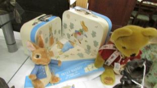A Peter Rabbit suitcase set, a Peter Rabbit soft toy and a Hamleys Teddy bearl