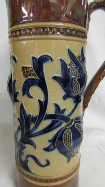 A 10.5" tall jug by Royal Doulton. Cream ground for main body and brown for the top and bottom. - Image 2 of 4
