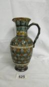 An 8.5" tall Doulton Lambeth 1890 highly patterned jug. Several marks on base including those of
