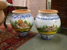 A magnificent pair of terracotta hand painted urns. Collect only.