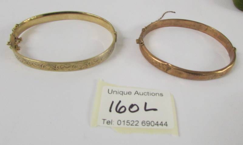 Two 9ct gold bangles, 26.5 grams (one has dents).