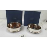 A boxed pair of Carr's hall marked silver wine coasters. Both in as new condition