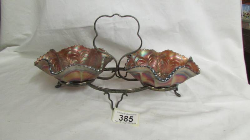 A pair of Fenton amethyst and gold peacock tail dishes on a plated stand.