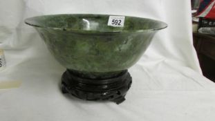 A large jade bowl on stand, 23 cm diameter.