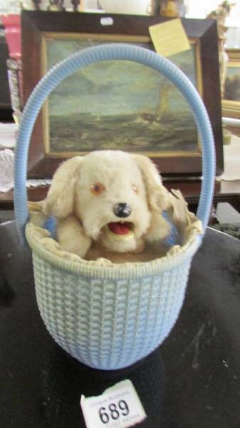 A Rock Valley Toys wind up dog in basket. (In working order)