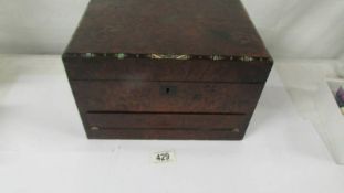 A Victorian Ladies Amboyna jewellery box/writing box. Some veneer loss to sides & around hinge on