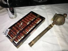 A Tibetan prayer wheel & an abacus