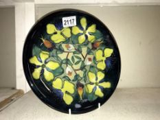 A Moorcroft Hypercium pattern plate, approximately 10.25" dimeter, second quality, line through W.M