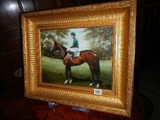 A gilt framed print of a racehorse.