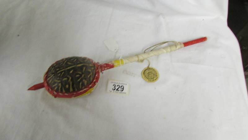A vintage Indian made tortoise shell rattle instrument.