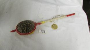 A vintage Indian made tortoise shell rattle instrument.