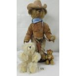 A cowboy teddy bear and two others.