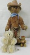 A cowboy teddy bear and two others.