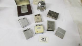 Six vintage cigarette lighters, two match holders and a 1942 calendar.