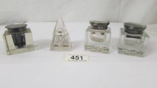 A pair of glass inkwells and two others,