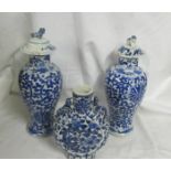 A pair of early Chinese blue and white lidded vases (both lids a/f) and a blue and white flask.