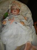 A large Victorian porcelain baby doll in moses basket. Marked AM. Collect only.