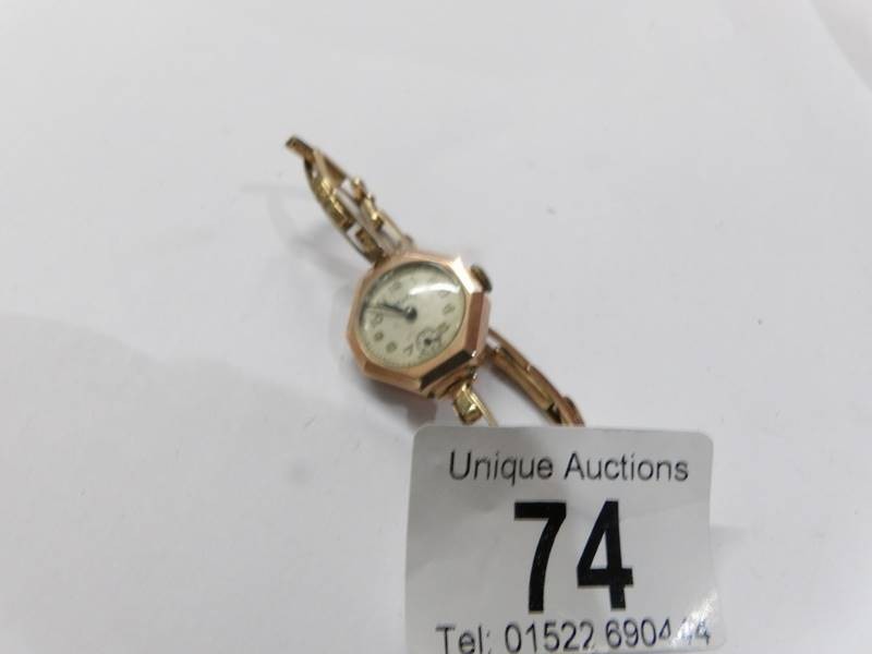 An art deco 9ct gold cased Majex ladies wrist watch on rolled gold strap. in working order.