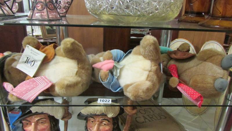 Three Peter Rabbit soft toys.