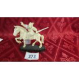 An antique carved ivory warrior on horse. Fixed to base. weight 73.6gms. Length 10cm, height 8.