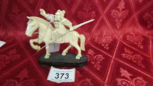 An antique carved ivory warrior on horse. Fixed to base. weight 73.6gms. Length 10cm, height 8.