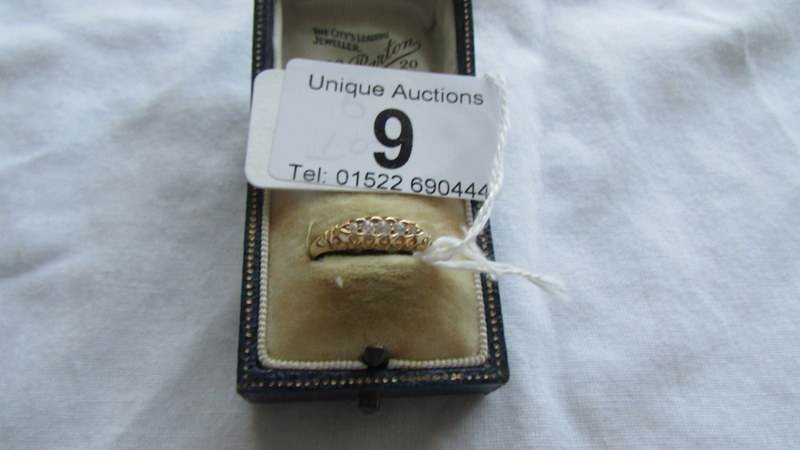 An 18ct gold five stone ring, size N. Weight 2.4g