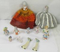 A mixed lot of pin cushion dolls including two on tea cosies.