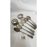 Six silver teaspoons and two silver napkin rings, approximately 100 grams.