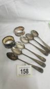 Six silver teaspoons and two silver napkin rings, approximately 100 grams.