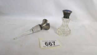 A glass perfume bottle with silver enamelled top and a decanter stopper with silver and enamel top.