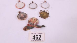 Two portrait pendants, three pendant mounts and a royalty badge.