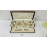 A cased Asprey fully hallmarked sterling silver writing garniture. Glass liner for ink well has a