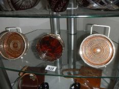 A pair of silver plate wine coasters and one other.