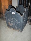 A heavy square cast iron plant stand, 30 cm square by 37 cm tall.