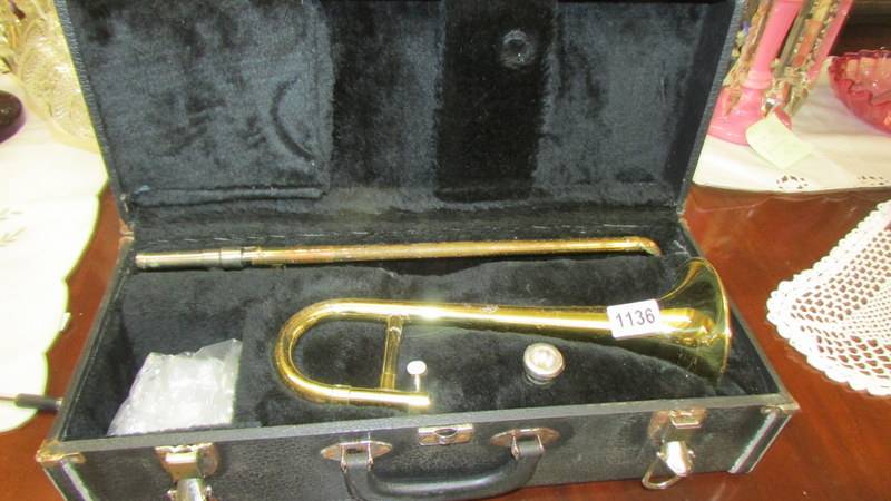 A rare small trombone in case.