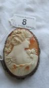 A large carved cameo of a female profile as a brooch.