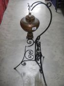 A copper kettle on wrought iron stand. Collect only.