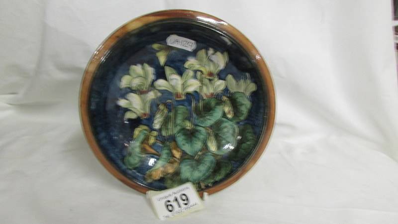 A Doulton Lambeth Faience pretty shallow dish painted with cyclamen and butterfly, also painted