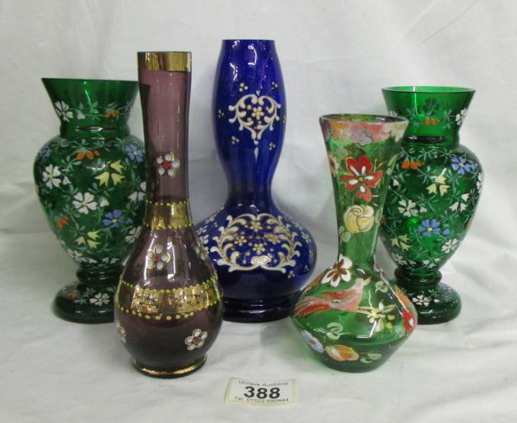 A pair of hand decorated green glass vases and three others. Collect only. Both green vases have a