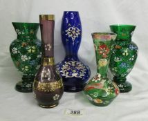 A pair of hand decorated green glass vases and three others. Collect only. Both green vases have a