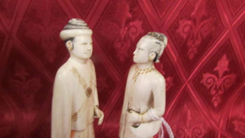 A pair of antique carved ivory figures on a wooden base. Neither figures have any damage but have - Image 2 of 2